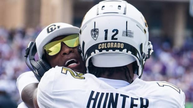 Colorado Buffaloes coach Deion Sanders hugs Travis Hunter at TCU